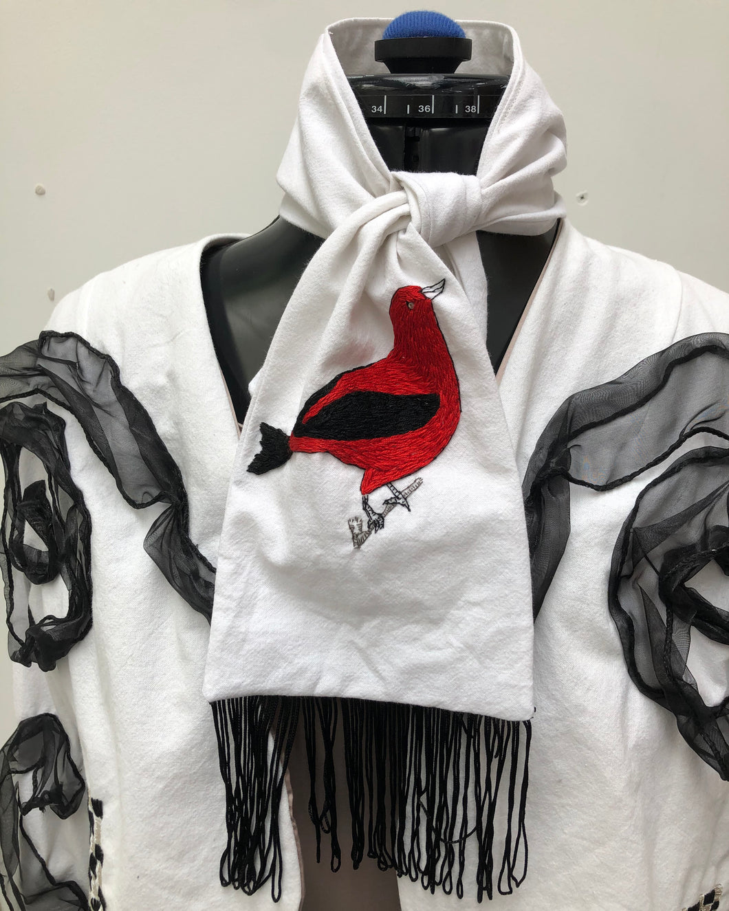 White cotton scarf with hand-embroidered Red Tanager bird motif with black tassels